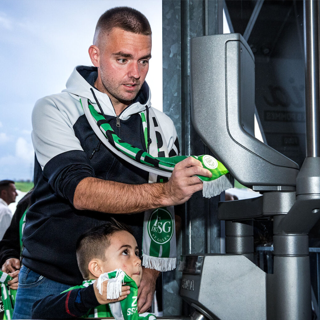 a man and child standing next to a machine