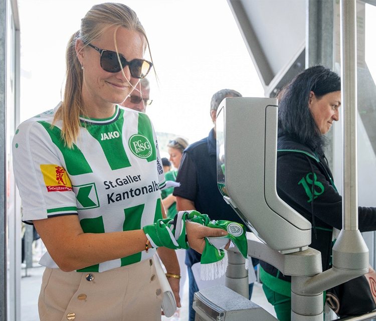 a woman wearing sunglasses and a green and white shirt