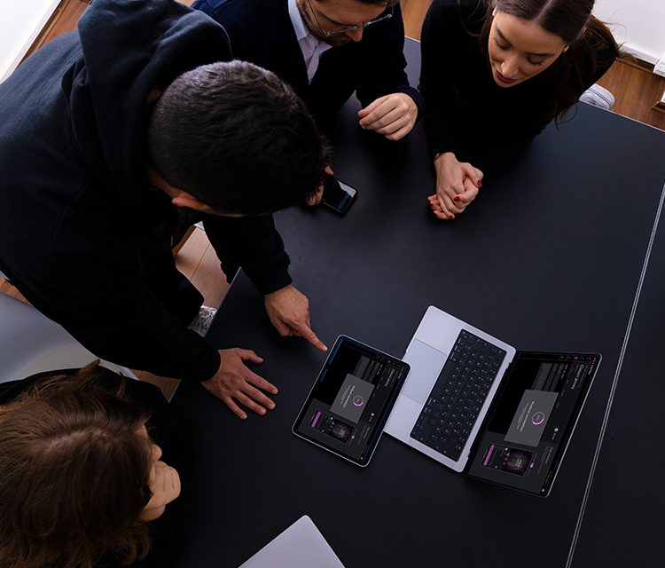 a group of people looking at a tablet