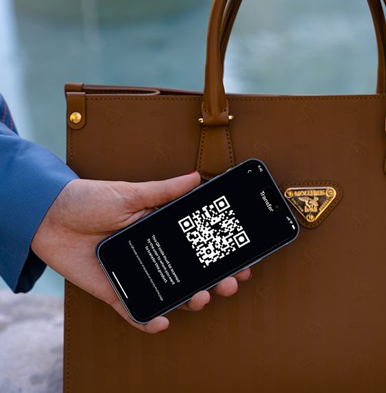 a hand holding a phone with qr code on it