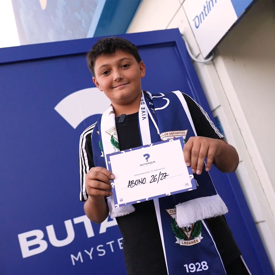 happy kid winning the content of the mystery box holding a price
