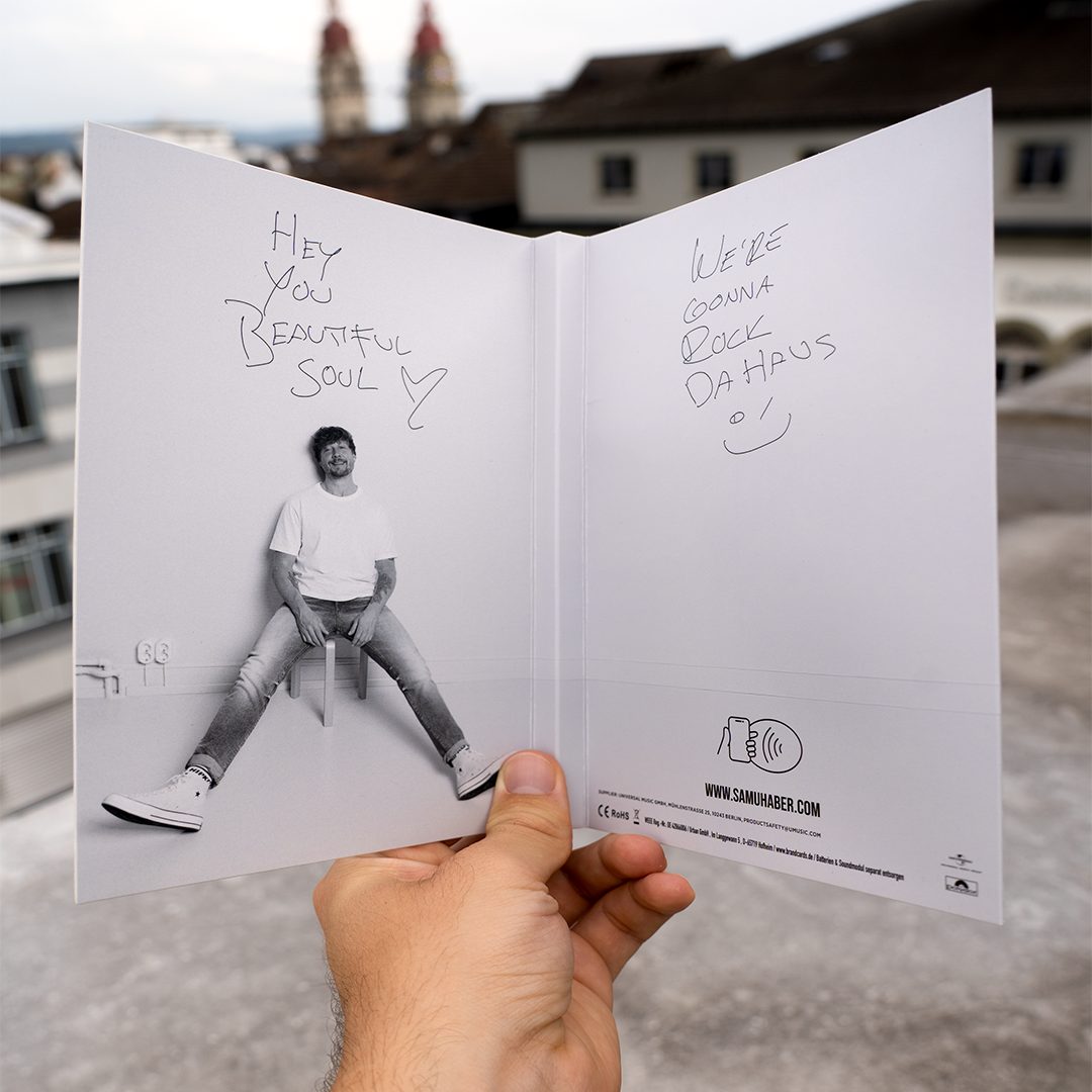 The NFC enables birthday invitation card of Samu Haber in front of a city background