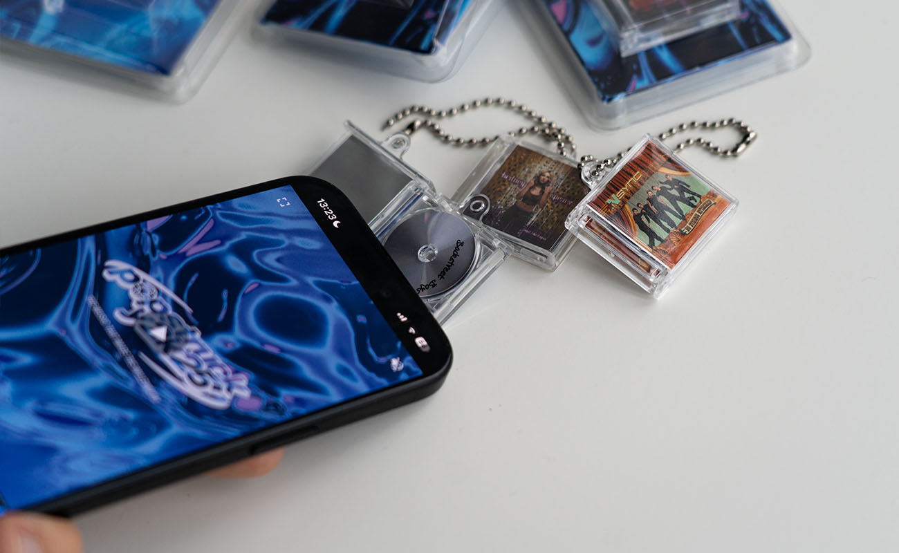 mini cd's tapped by a smartphone showing a video